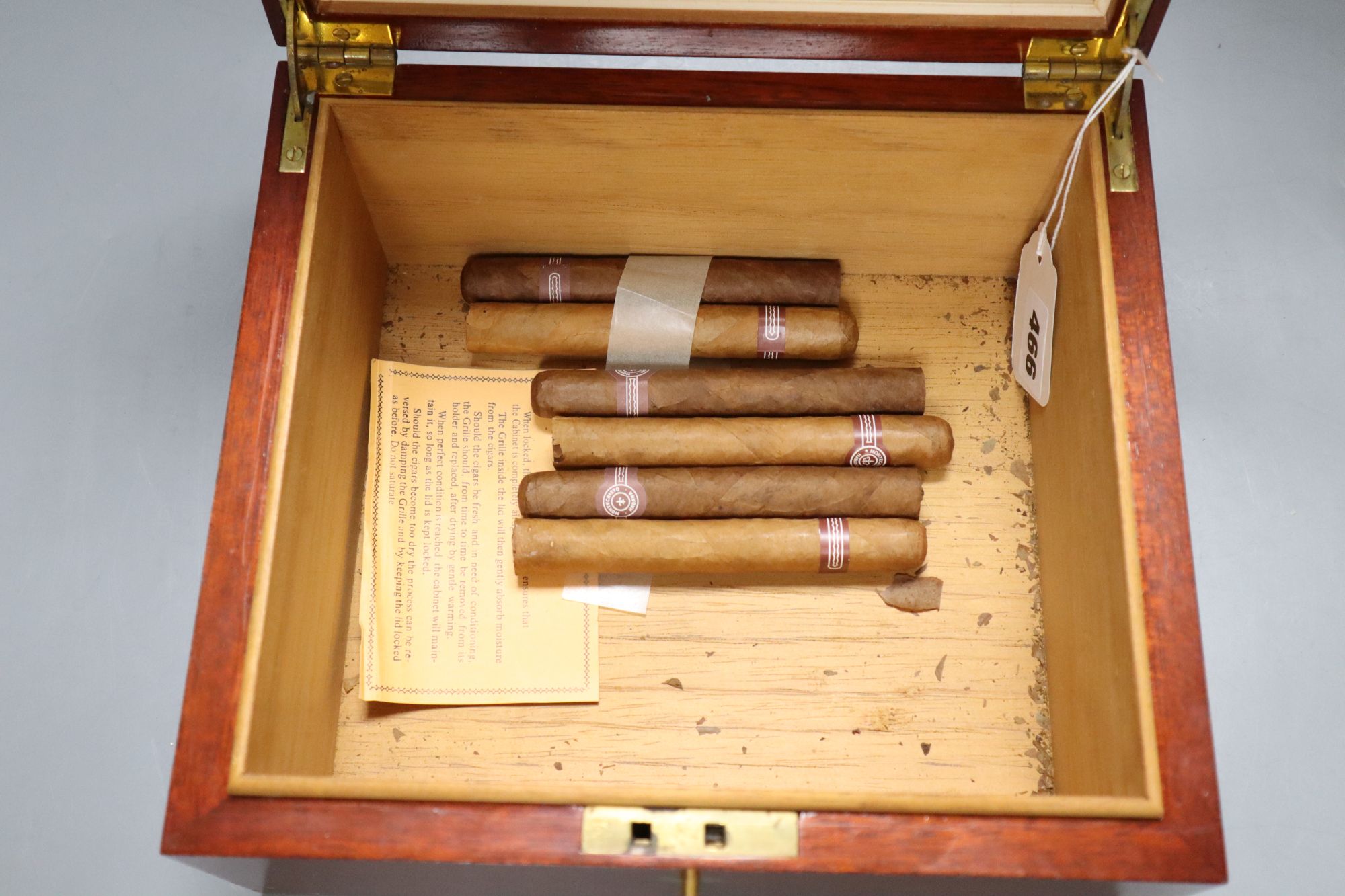 A humidor and six loose cigars